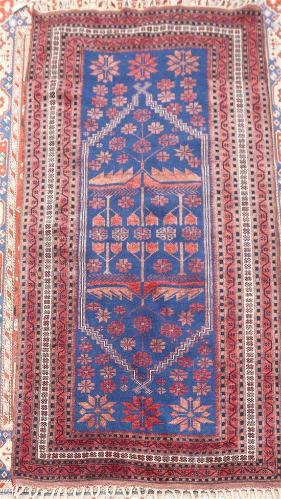 A Turkish blue and red rug, woven with a hexagonal medallion 184 x 185cm